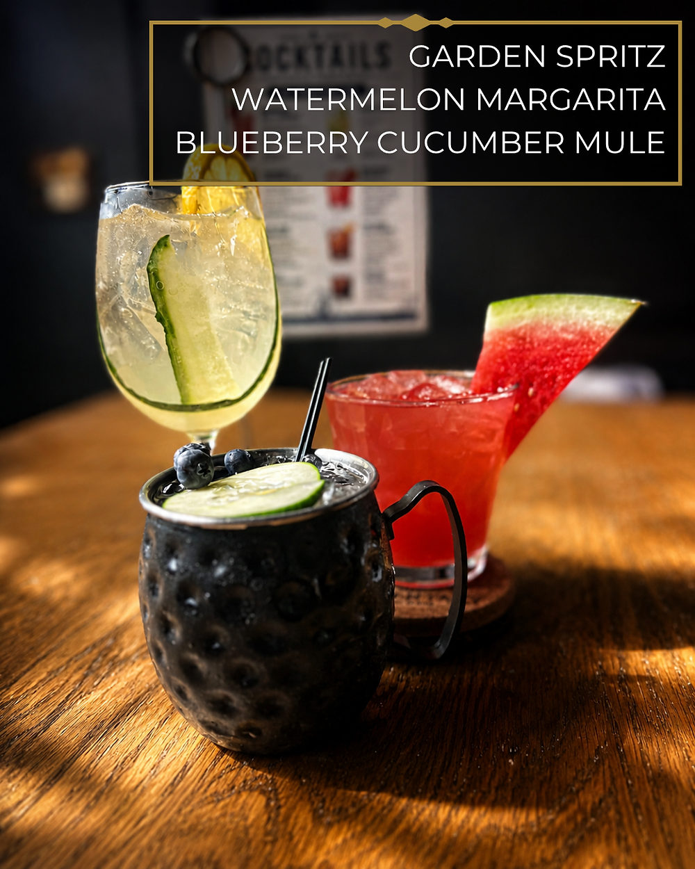 Garden Spritz, Watermelon Margarita and Blueberry Cucumber Mule on a wooden table.