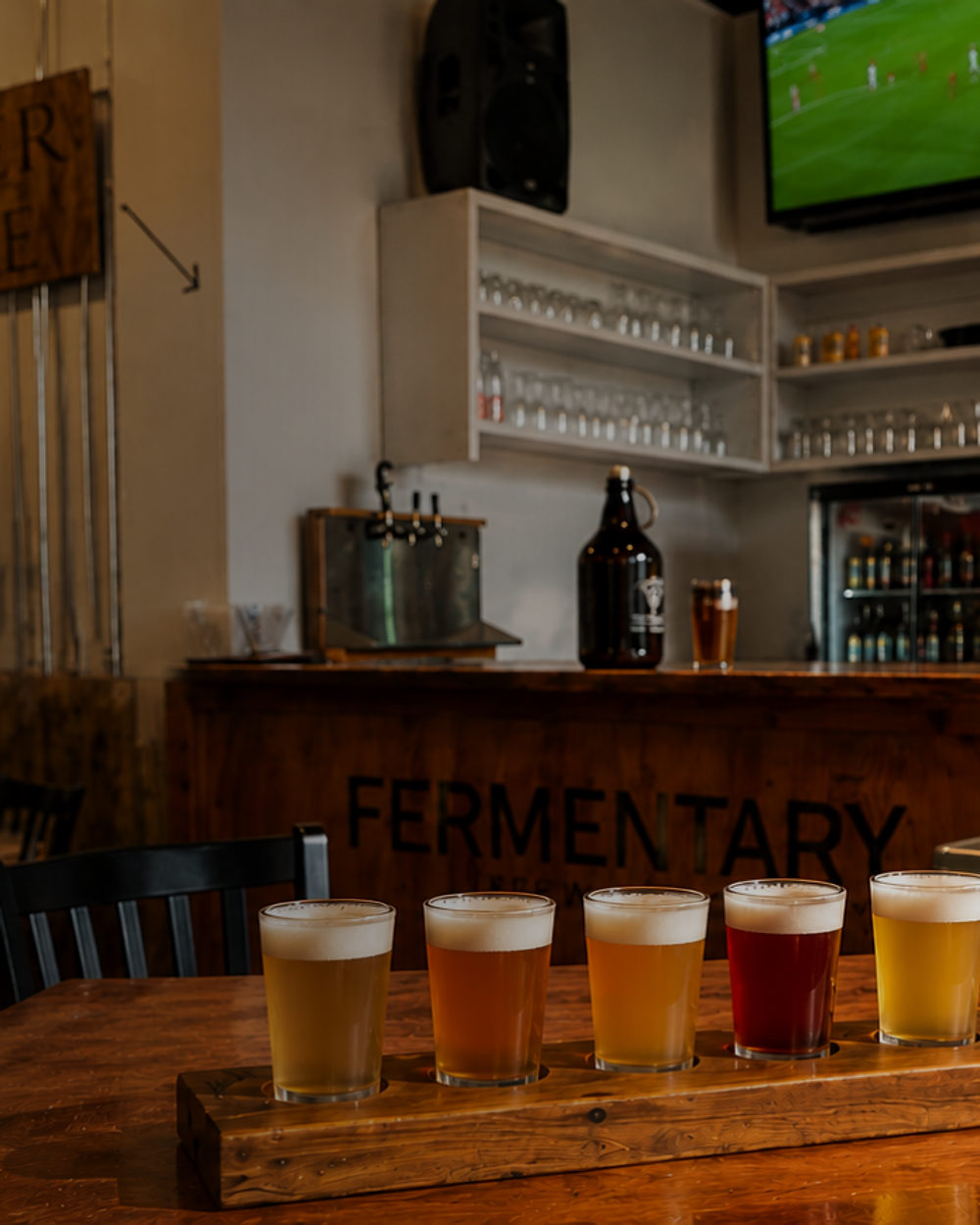 A flight of five house beers on a paddle in the brewery.