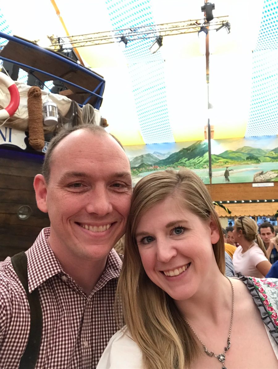 Co-owners Larry and Becky McCallister smiling together in a festival beer hall.